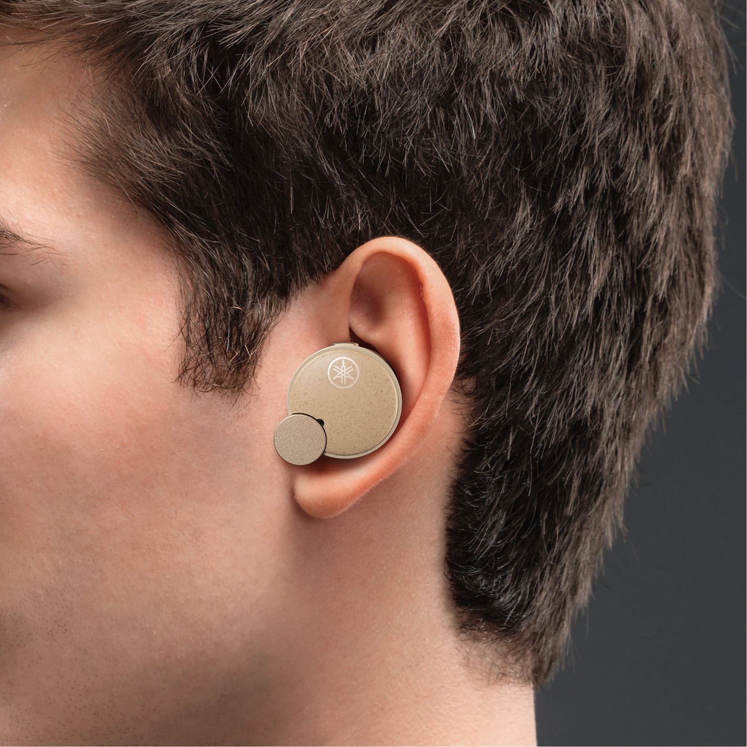 TW-E7B-resized Closeup of an earbud in a person's ear.